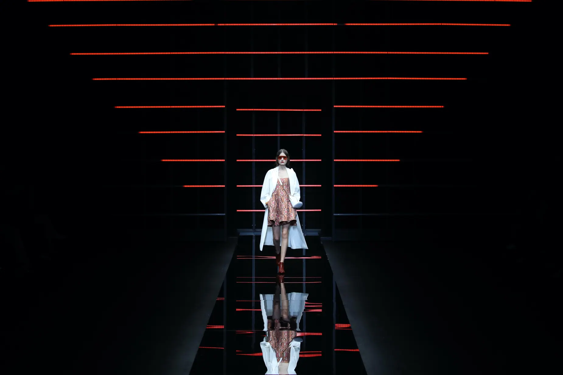 Single model within graphic red-lit Emporio Armani set