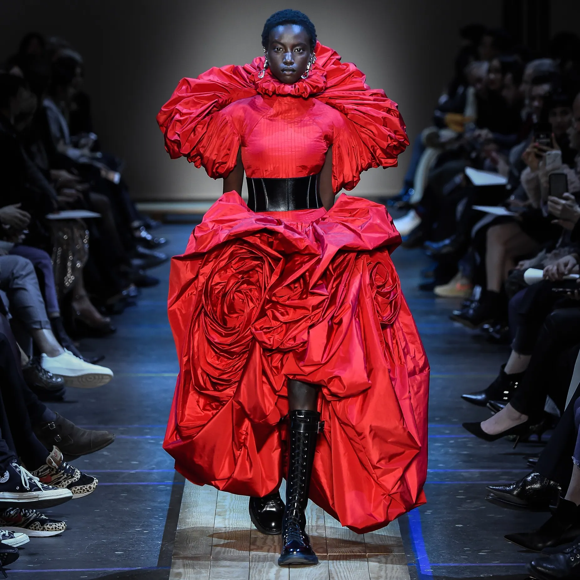 Model in dramatic bright red Alexander McQueen runway look